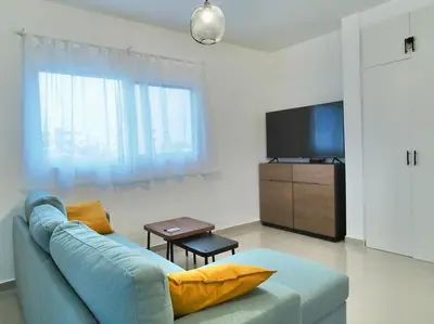 a living room with a blue couch and a television at Mar Azul in Bayahibe