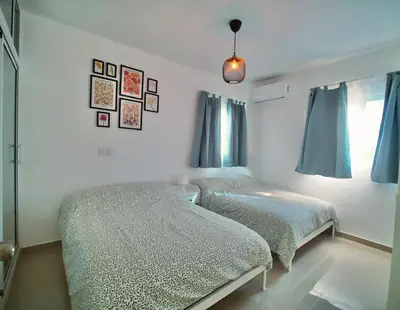 a bedroom with two beds and a window at Mar Azul in Bayahibe