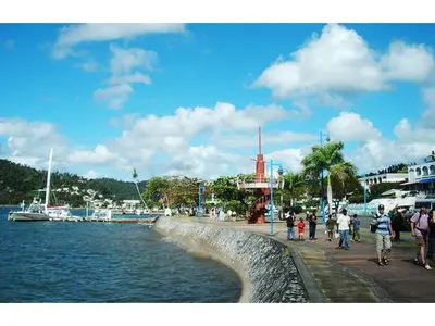 a group of people walking on a sidewalk next to a body of water at Best bed and breakfast in Samana Breakfast Included in Santa Bárbara de Samaná