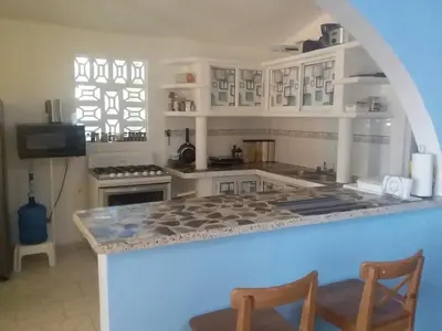 a kitchen with a counter with a stove top oven at Best bed and breakfast in Samana Breakfast Included in Santa Bárbara de Samaná