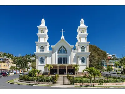 a large white church with two towers on a street at Best bed and breakfast in Samana Breakfast Included in Santa Bárbara de Samaná