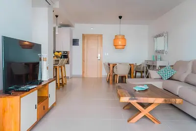 a living room with a couch and a table at Beach Garden I F3 Luxury Condo in Punta Cana