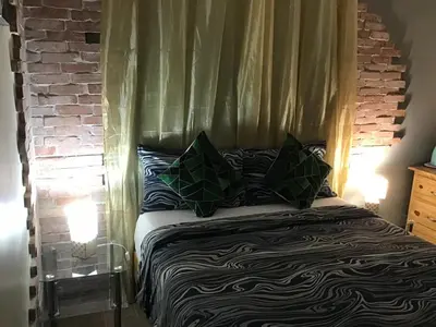 a bedroom with a bed with a canopy at El Conde De Atrini in Santo Domingo