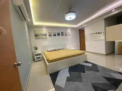 a bedroom with a bed with a yellow blanket at Privada tipo cabaña Con amplio patio in Santiago de los Caballeros