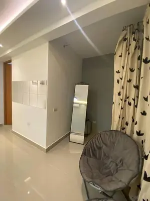 a room with a chair and a mirror in it at Privada tipo cabaña Con amplio patio in Santiago de los Caballeros