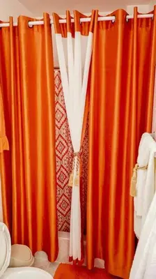 an orange curtain in a bathroom next to a toilet at Apartamento en la Romana 2 días en adelante in La Romana