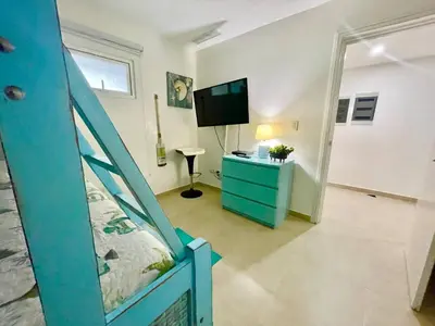a bedroom with a bunk bed and a tv in a room at 2 Bedroom At The Marbella Towers Beachfront in Juan Pedro
