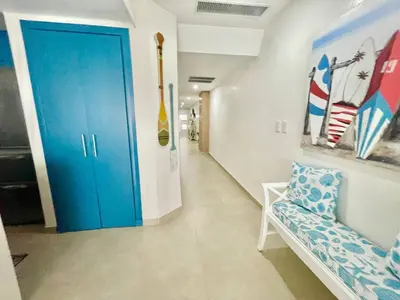 a hallway with a blue door in a room at 2 Bedroom At The Marbella Towers Beachfront in Juan Pedro