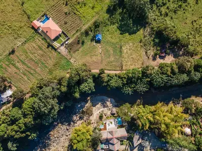 an aerial view of a house next to a river at Sunflower village villa girasoles in Jarabacoa