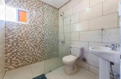 a bathroom with a toilet and a sink at Sunflower village villa girasoles in Jarabacoa