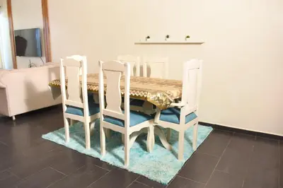 a dining room table with four chairs around it at Dpto Dream Village Boca Chica frente a la playa in Boca Chica