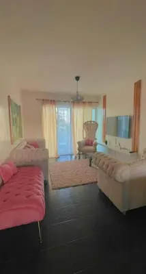 a living room with two couches and a red couch at Dpto Dream Village Boca Chica frente a la playa in Boca Chica