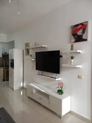 a living room with a flat screen tv on a wall at The most comfortable apartment in Boca Chica in Boca Chica