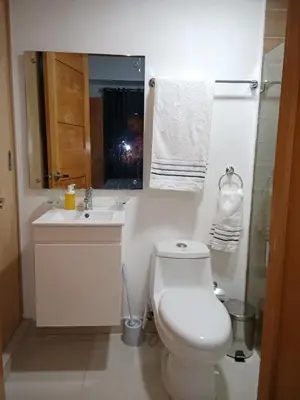 a bathroom with a toilet and a sink and a mirror at The most comfortable apartment in Boca Chica in Boca Chica