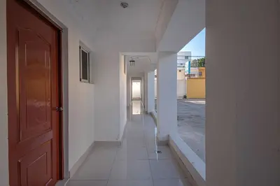 an empty hallway of a building with a door at Comfort Double Room - Corales del Sur Ole Las Americas- Isabelita - Aeropuerto in La Viva
