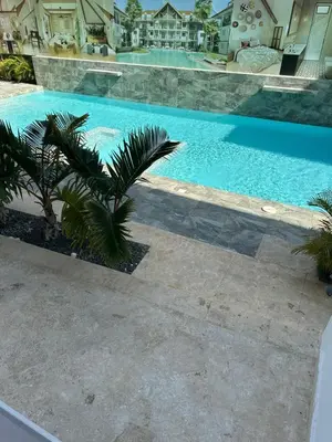 a large swimming pool with a palm tree next to it at Esprit Caribbean Bayahibe in Bayahibe