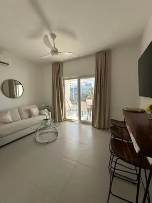 a living room with a couch and a ceiling fan at Esprit Caribbean Bayahibe in Bayahibe