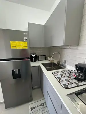 a kitchen with a stainless steel refrigerator and a sink at Esprit Caribbean Bayahibe in Bayahibe