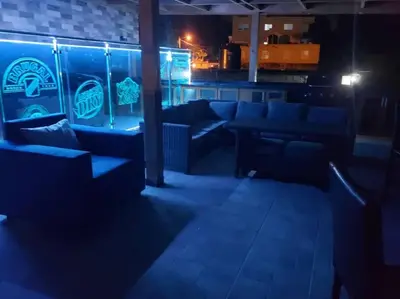 a bar with couches and tables in a dark room at Villa Bellevue in San Felipe de Puerto Plata
