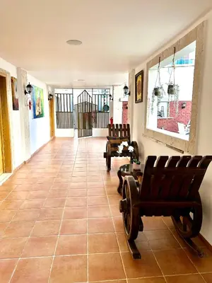 a hallway with chairs and aoyer with a gate at Noe Hotel Punta Cana in Punta Cana