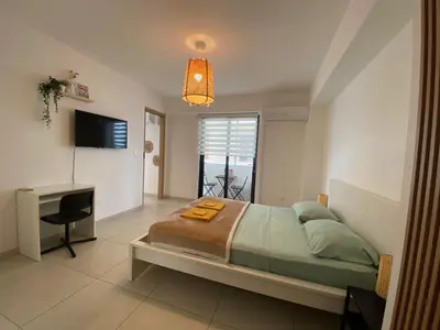 a bedroom with a bed and a desk and a television at Hermoso refugio céntrico in Santo Domingo