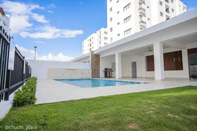 a swimming pool in the courtyard of a building at Chuchi Place in Santiago de los Caballeros