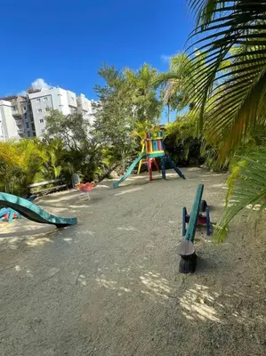 a playground with a colorful slide in a park at Mountain View Cibao in Santiago de los Caballeros