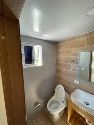 a bathroom with a toilet and a sink at Mountain View Cibao in Santiago de los Caballeros