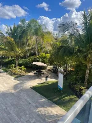 a view of a park with a picnic table and palm trees at Mountain View Cibao in Santiago de los Caballeros