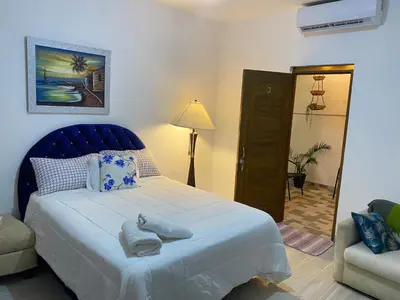 a bedroom with a blue bed with towels on it at Only Room By Merengue House, 8 minutos airport in Monte Adentro