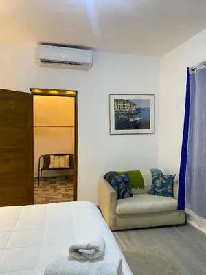 a bedroom with a bed and a couch at Only Room By Merengue House, 8 minutos airport in Monte Adentro