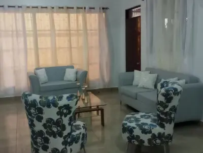 a living room with two chairs and a couch at Departamento Rosa in Santo Domingo