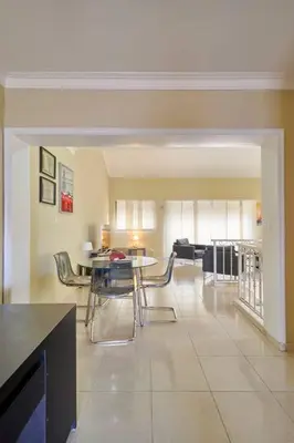 a kitchen and dining room with a table and chairs at Escape Penthouse near Blue Mall - 4BR with Private Rooftop & City Views in Santo Domingo