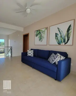 a blue couch in a living room with a ceiling fan at 2JA Management Group - SOV Properties in Sosúa