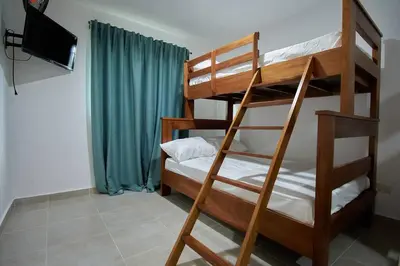 a bunk bed room with two bunk beds and a television at The apartment you dreamed of 1 in Santiago de los Caballeros