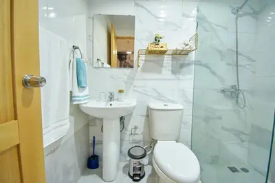 a bathroom with a toilet and a sink and a shower at The apartment you dreamed of 2 ! in Santiago de los Caballeros