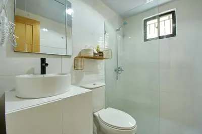a white bathroom with a sink and a toilet at The apartment you dreamed of 2 ! in Santiago de los Caballeros