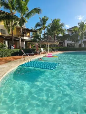 a pool at a resort with a person swimming in it at Esmeralda67 Tamarindo in Bayahibe
