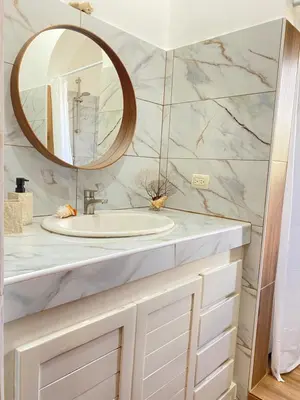 a bathroom with a sink and a mirror at Esmeralda67 Tamarindo in Bayahibe
