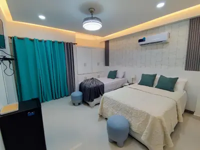 a bedroom with two beds in a room with green curtains at Hotel el barco in Azua de Compostela
