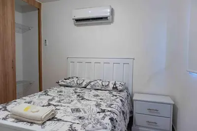 a bedroom with a bed and a air conditioner on the wall at 2 Bedrooms at Baia Residences in Santiago de los Caballeros