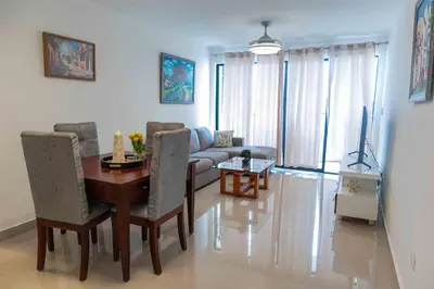 a living room with a table and a couch at 2 Bedrooms at Baia Residences in Santiago de los Caballeros