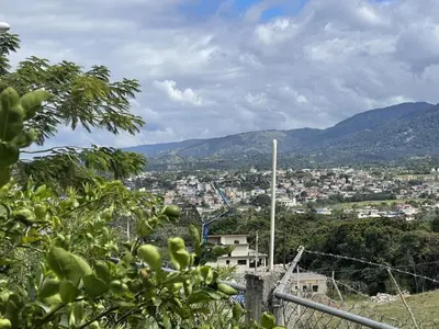 a view of a city with mountains in the background at Villa Ladera de la Montańa in Jarabacoa