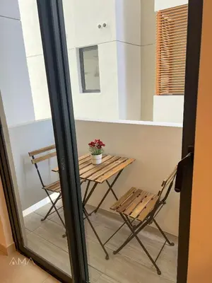 a table and chair in a room with a window at Acogedor Apartamento Céntrico in Santo Domingo