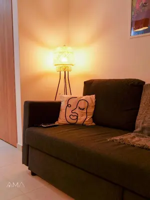 a pillow with a face on it sitting on a couch at Acogedor Apartamento Céntrico in Santo Domingo