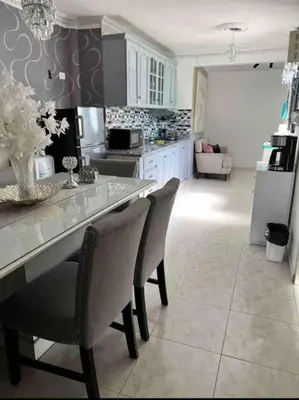 a kitchen with a counter top and chairs in a room at Malecon View, Zona Colonial in Santo Domingo