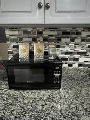 a microwave with two candles on top of it at Malecon View, Zona Colonial in Santo Domingo