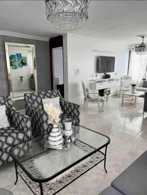 a living room with a couch and a table at Malecon View, Zona Colonial in Santo Domingo