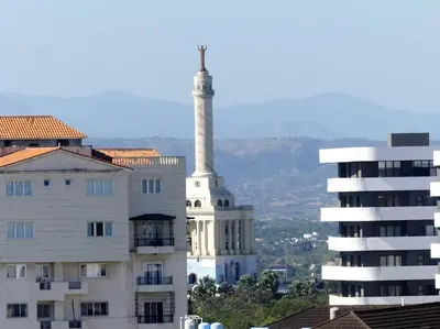 a building with a tower in front of a building at Dreams Room Soha II in Santiago de los Caballeros