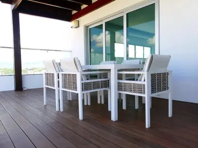 a white dining room table and chairs on a porch at Dreams Room Soha II in Santiago de los Caballeros
